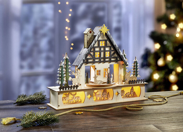 Beleuchtetes Waldhaus aus Holz 